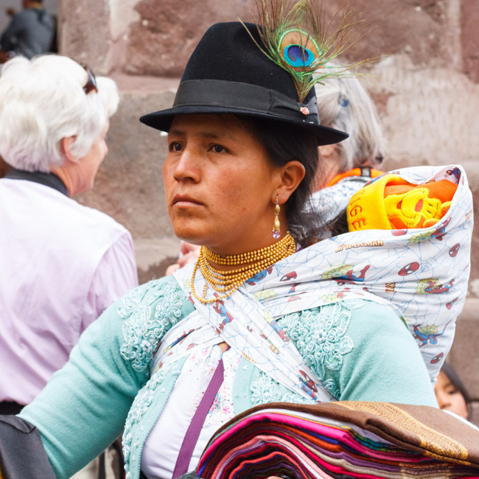 Woman with baby, selling scarves from Otavalo. Quito.